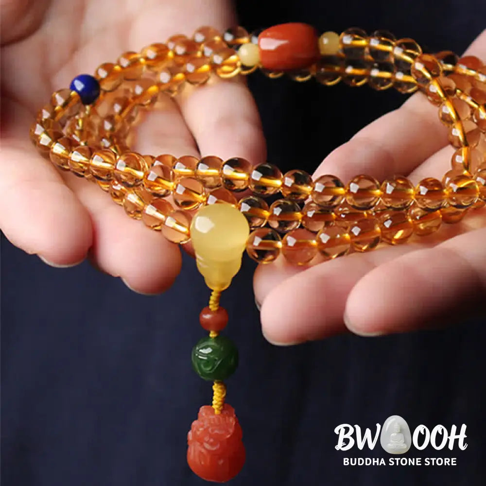 BWOOOH 108 Mala Beads bracelet featuring polished natural citrine, golden amber, and deep red agate, interspersed with a round peace buckle and a detailed gold-toned PiXiu charm on premium elastic string for wealth attraction and emotional balance. - View 20