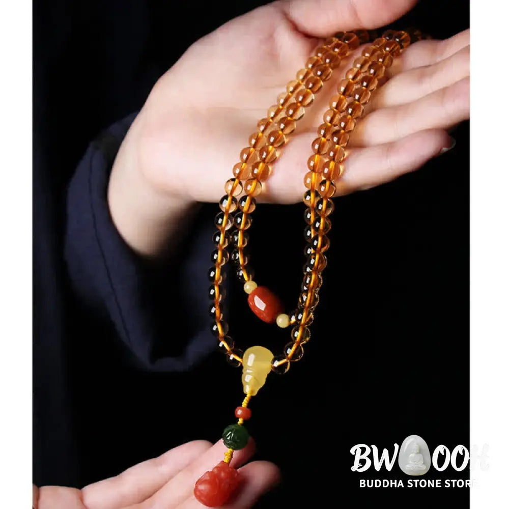 BWOOOH 108 Mala Beads bracelet featuring polished natural citrine, golden amber, and deep red agate, interspersed with a round peace buckle and a detailed gold-toned PiXiu charm on premium elastic string for wealth attraction and emotional balance. - View 25