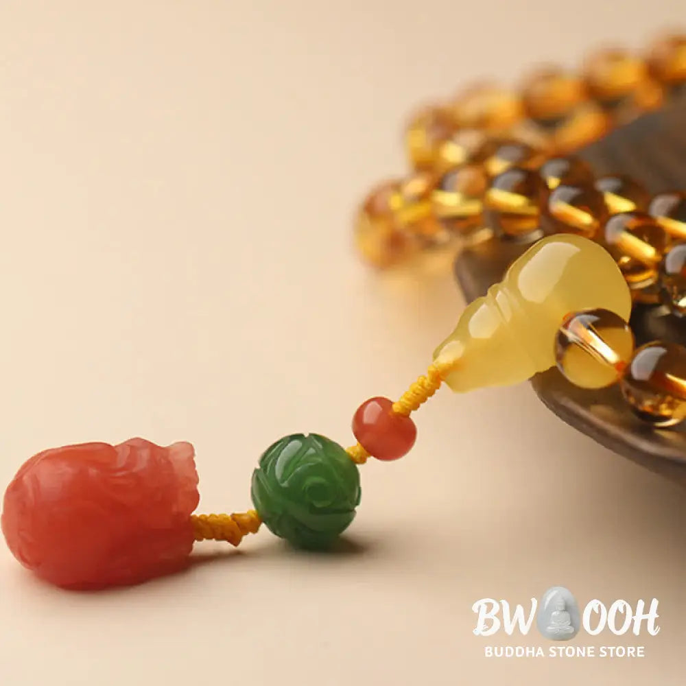 BWOOOH 108 Mala Beads bracelet featuring polished natural citrine, golden amber, and deep red agate, interspersed with a round peace buckle and a detailed gold-toned PiXiu charm on premium elastic string for wealth attraction and emotional balance. - View 26