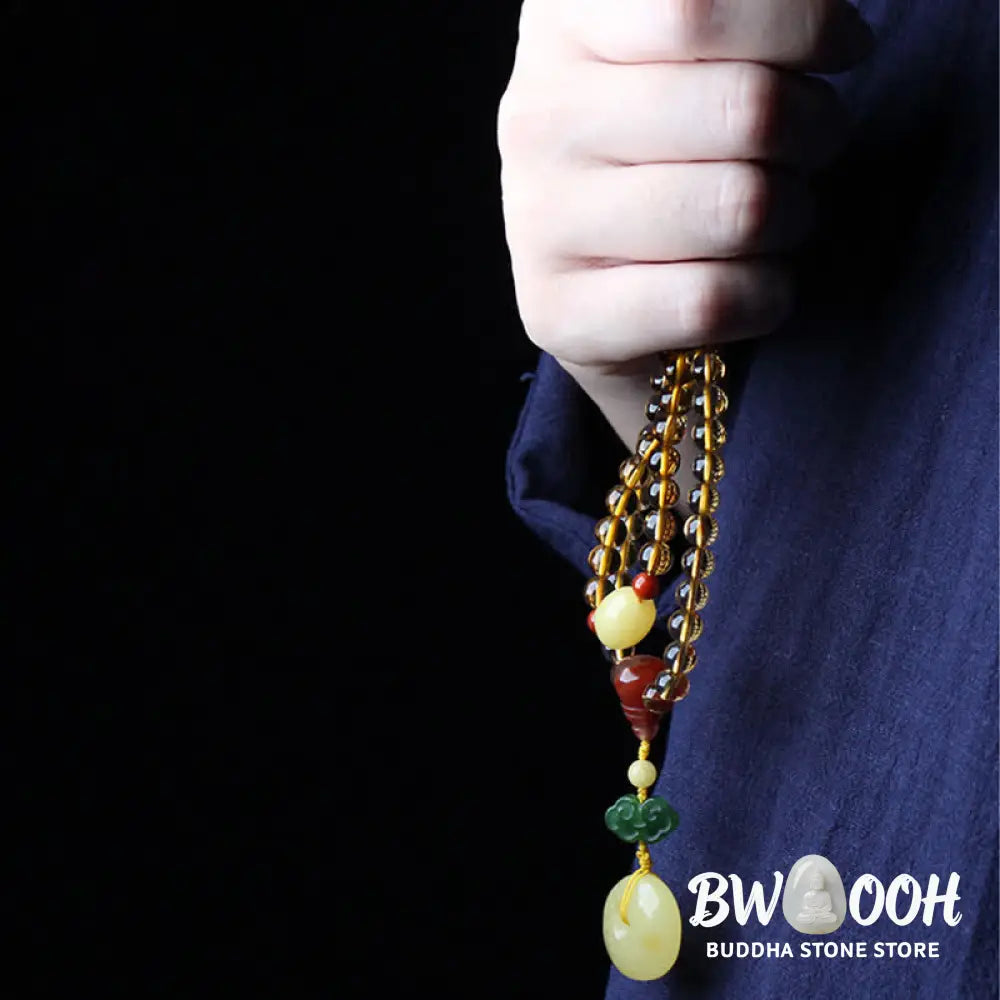 BWOOOH 108 Mala Beads bracelet featuring polished natural citrine, golden amber, and deep red agate, interspersed with a round peace buckle and a detailed gold-toned PiXiu charm on premium elastic string for wealth attraction and emotional balance. - View 8