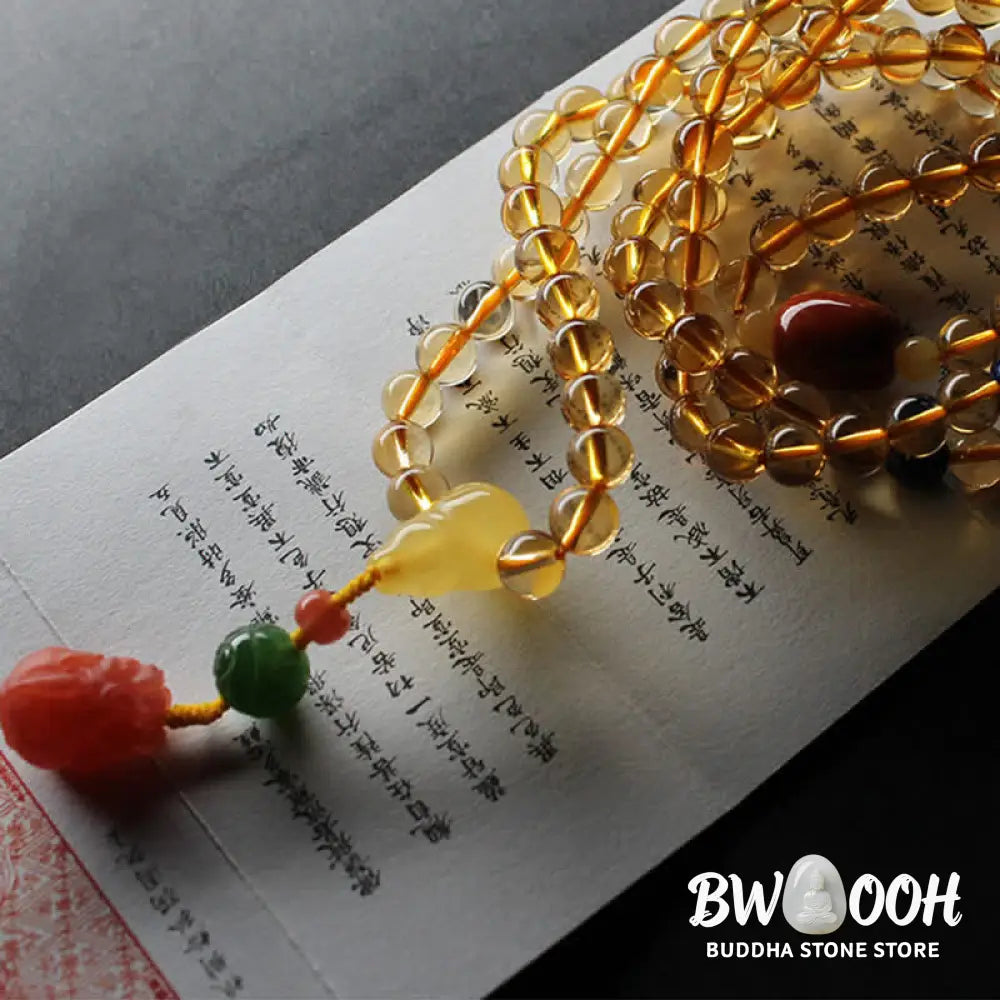 BWOOOH 108 Mala Beads bracelet featuring polished natural citrine, golden amber, and deep red agate, interspersed with a round peace buckle and a detailed gold-toned PiXiu charm on premium elastic string for wealth attraction and emotional balance. - View 23