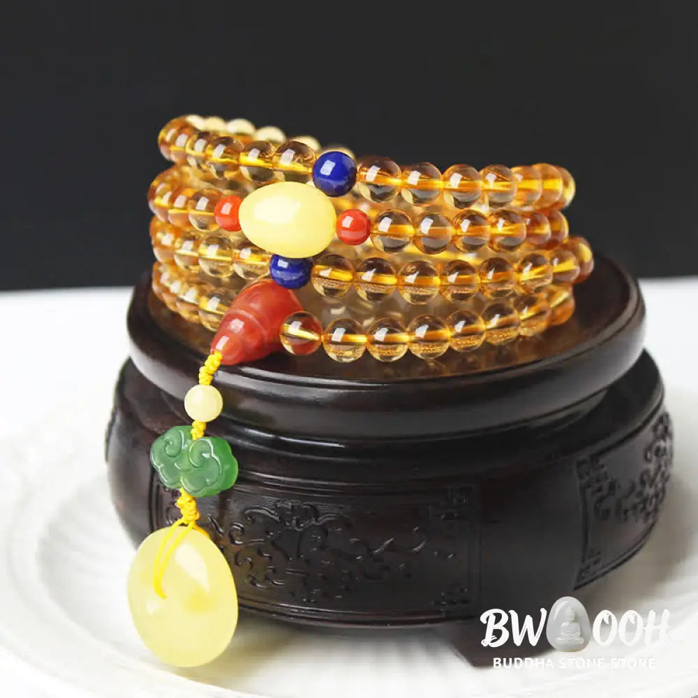 BWOOOH 108 Mala Beads bracelet featuring polished natural citrine, golden amber, and deep red agate, interspersed with a round peace buckle and a detailed gold-toned PiXiu charm on premium elastic string for wealth attraction and emotional balance. - View 2