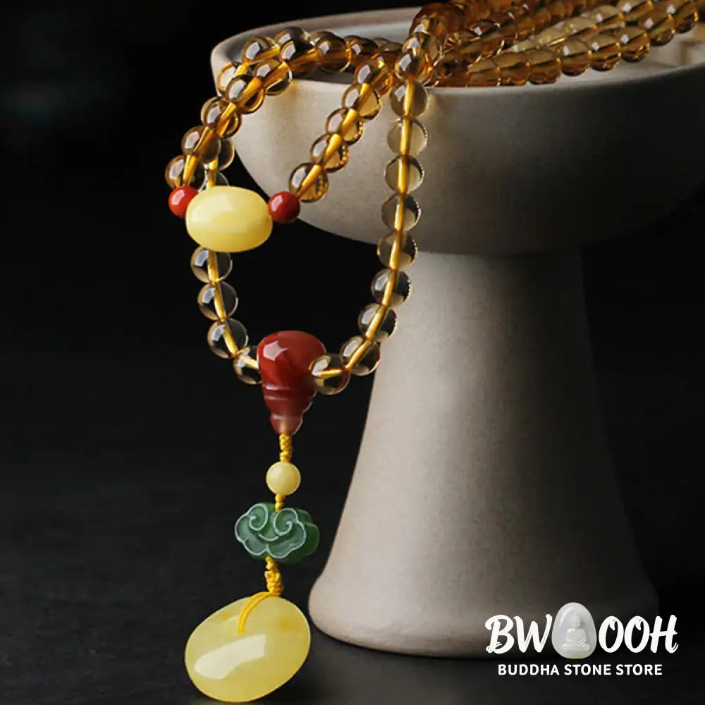 BWOOOH 108 Mala Beads bracelet featuring polished natural citrine, golden amber, and deep red agate, interspersed with a round peace buckle and a detailed gold-toned PiXiu charm on premium elastic string for wealth attraction and emotional balance. - View 10
