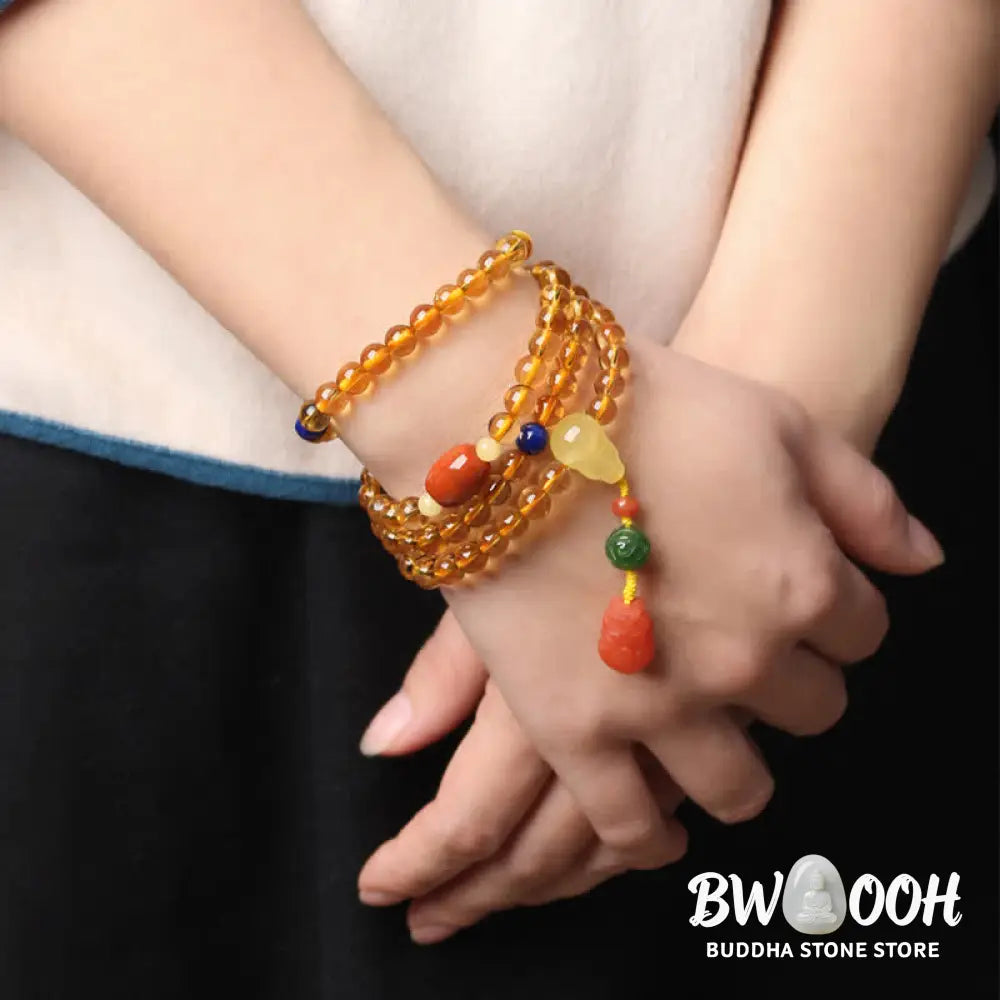 BWOOOH 108 Mala Beads bracelet featuring polished natural citrine, golden amber, and deep red agate, interspersed with a round peace buckle and a detailed gold-toned PiXiu charm on premium elastic string for wealth attraction and emotional balance. - View 19