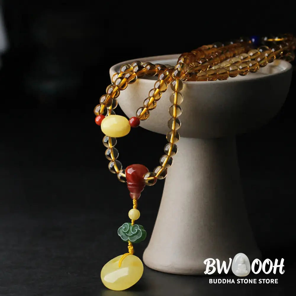 BWOOOH 108 Mala Beads bracelet featuring polished natural citrine, golden amber, and deep red agate, interspersed with a round peace buckle and a detailed gold-toned PiXiu charm on premium elastic string for wealth attraction and emotional balance. - View 13