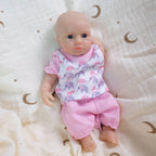Luna 8-inch solid silicone baby doll, water-safe, with movable limbs and soft, lifelike features.
