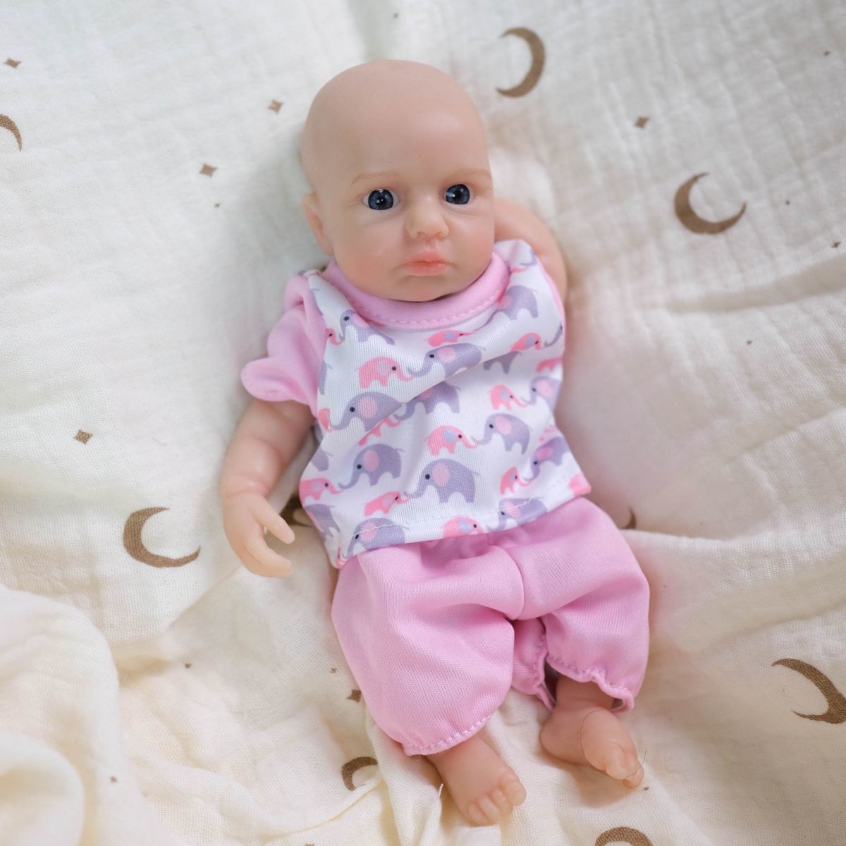 Luna 8-inch solid silicone baby doll, water-safe, with movable limbs and soft, lifelike features.