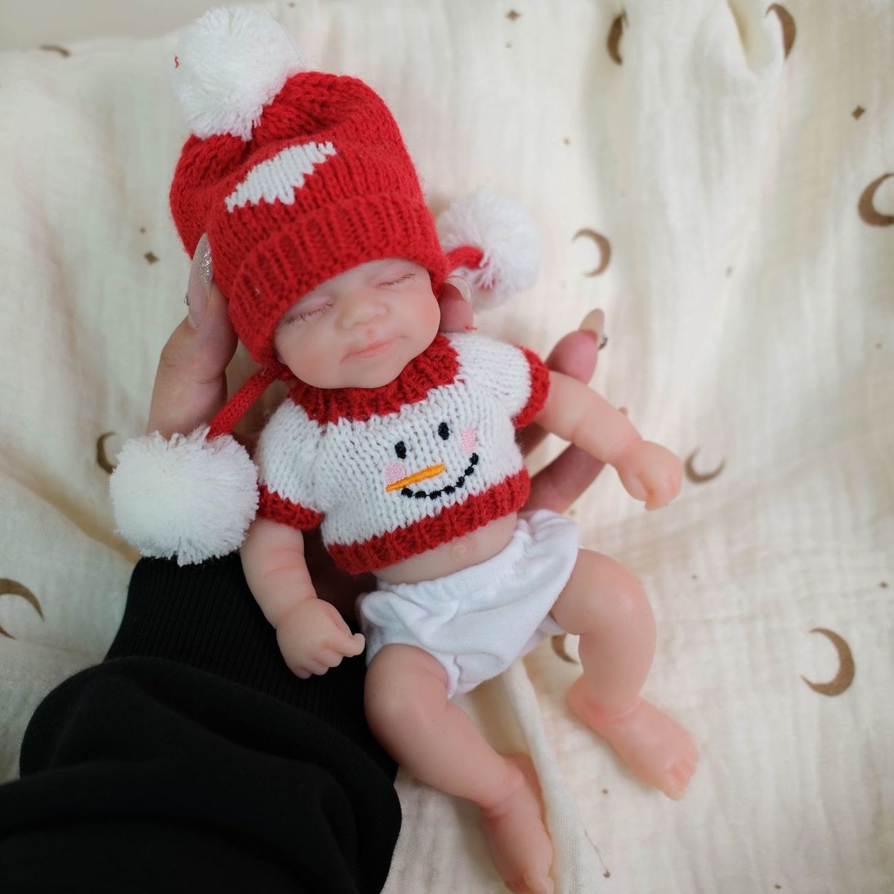 Mia 8-inch all-silicone baby doll, bathable, with flexible limbs, Christmas-themed lifelike baby figurine.