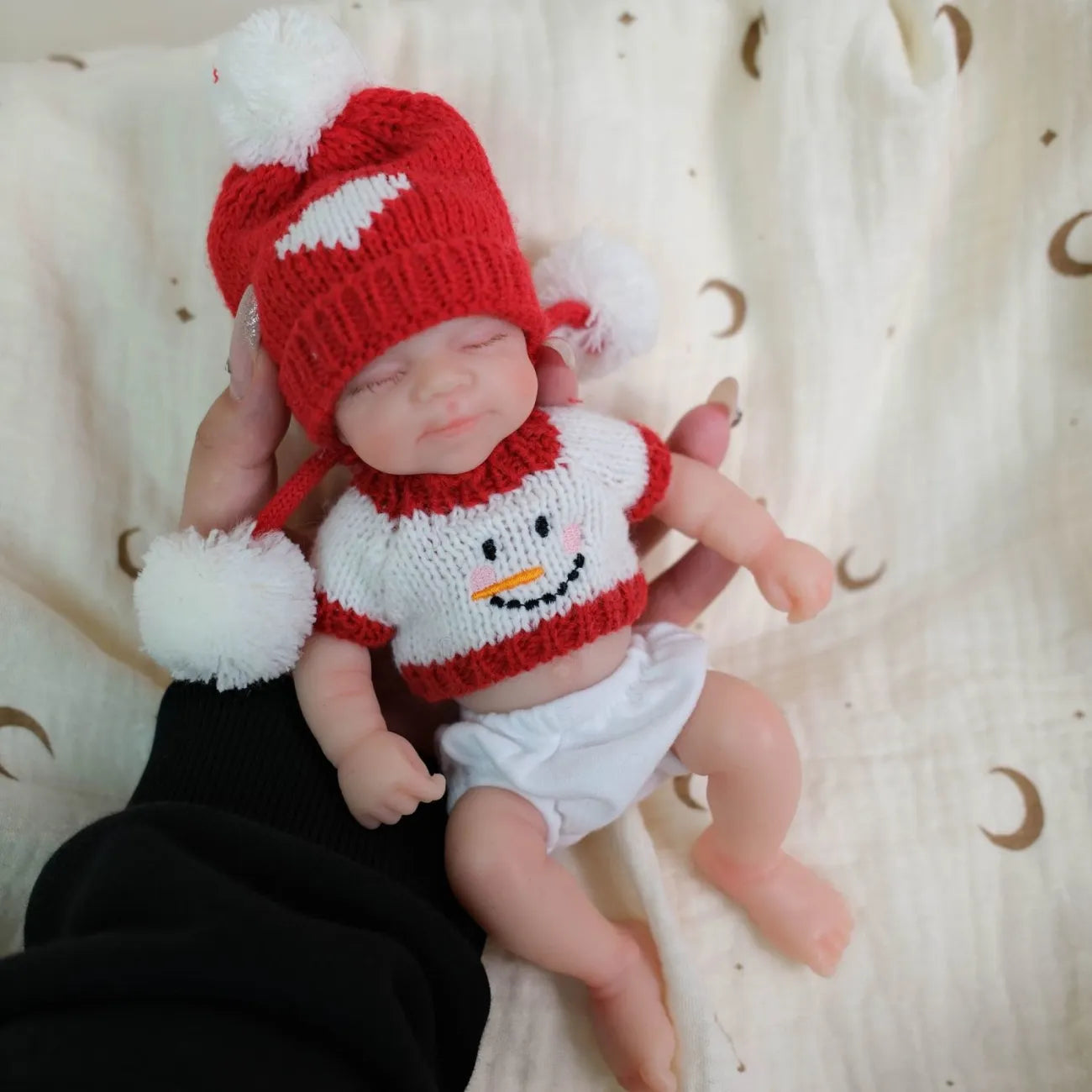 Mia 8-inch all-silicone baby doll, bathable, with flexible limbs, Christmas-themed lifelike baby figurine.