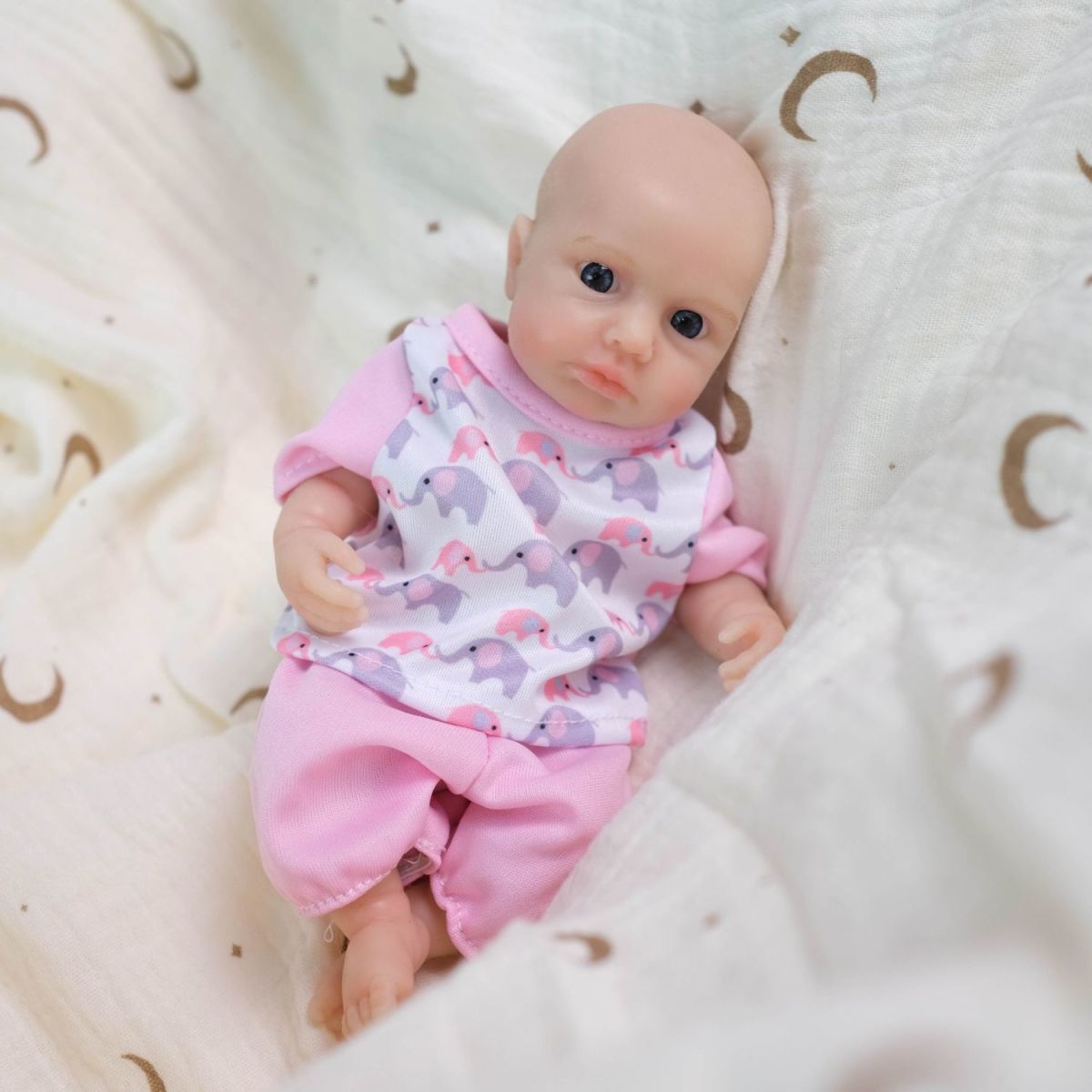 Luna 8-inch solid silicone baby doll, water-safe, with movable limbs and soft, lifelike features.