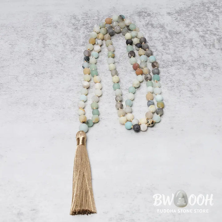 BWOOOH 108 Amazonite Beads Tassel Mala Bracelet on a natural wooden surface, showcasing its serene 6mm blue-green amazonite beads and an intricately woven tassel, reflecting spiritual balance and mindfulness. - View 3