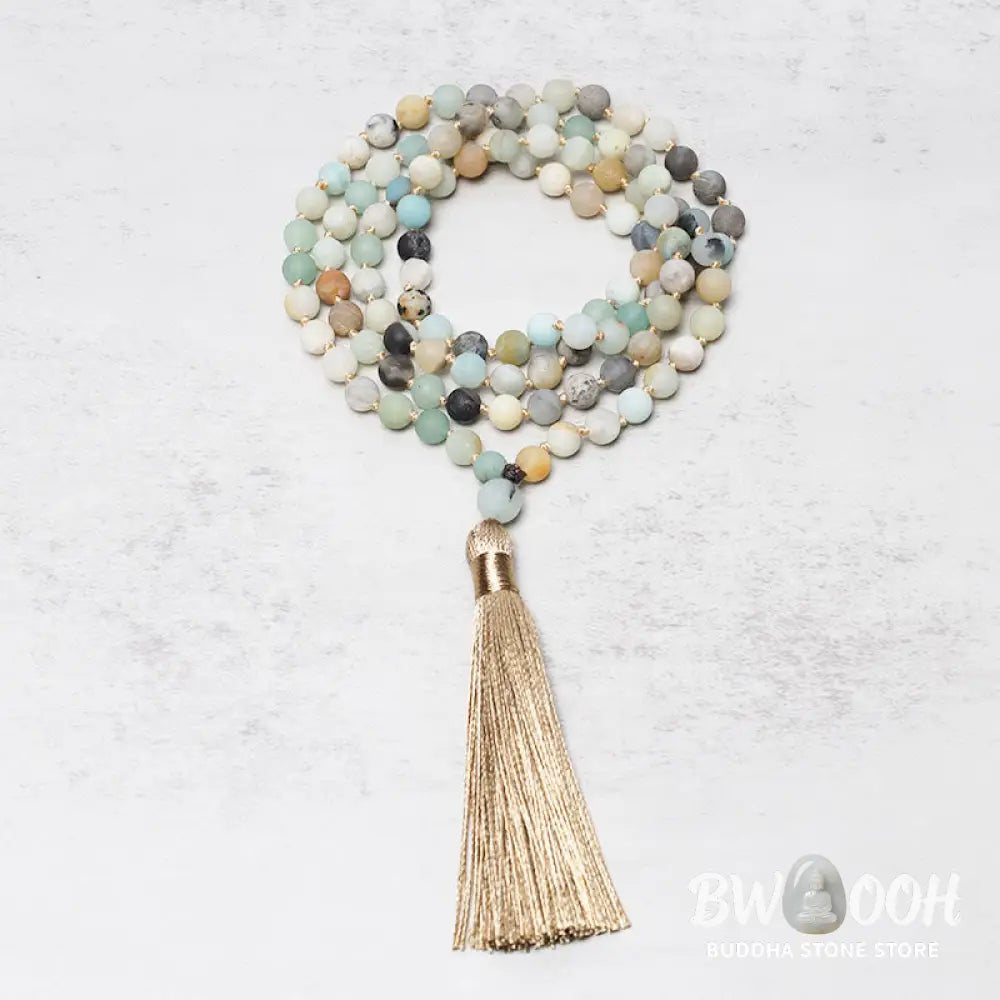 BWOOOH 108 Amazonite Beads Tassel Mala Bracelet on a natural wooden surface, showcasing its serene 6mm blue-green amazonite beads and an intricately woven tassel, reflecting spiritual balance and mindfulness. - View 2
