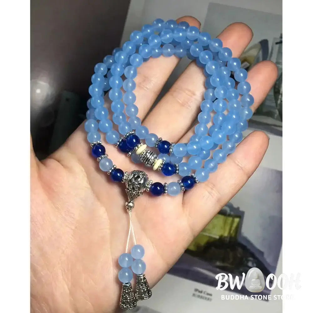 A BWOOOH 108-bead Blue Crystal Healing Mala Bracelet, featuring shimmering 6mm blue crystal beads, styled as a versatile bracelet and necklace. The natural variations in the blue crystals are visible, emphasizing its serene and handcrafted quality, perfect for meditation and spiritual balance. - View 10