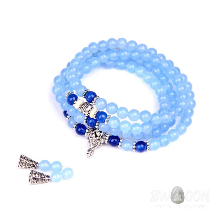 A BWOOOH 108-bead Blue Crystal Healing Mala Bracelet, featuring shimmering 6mm blue crystal beads, styled as a versatile bracelet and necklace. The natural variations in the blue crystals are visible, emphasizing its serene and handcrafted quality, perfect for meditation and spiritual balance. - View 11