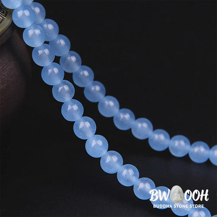 A BWOOOH 108-bead Blue Crystal Healing Mala Bracelet, featuring shimmering 6mm blue crystal beads, styled as a versatile bracelet and necklace. The natural variations in the blue crystals are visible, emphasizing its serene and handcrafted quality, perfect for meditation and spiritual balance. - View 9