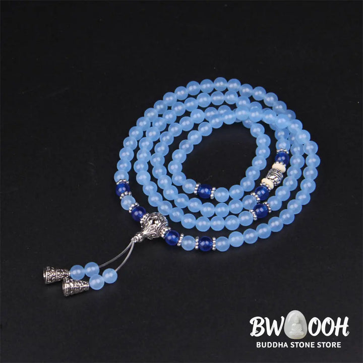 A BWOOOH 108-bead Blue Crystal Healing Mala Bracelet, featuring shimmering 6mm blue crystal beads, styled as a versatile bracelet and necklace. The natural variations in the blue crystals are visible, emphasizing its serene and handcrafted quality, perfect for meditation and spiritual balance. - View 4