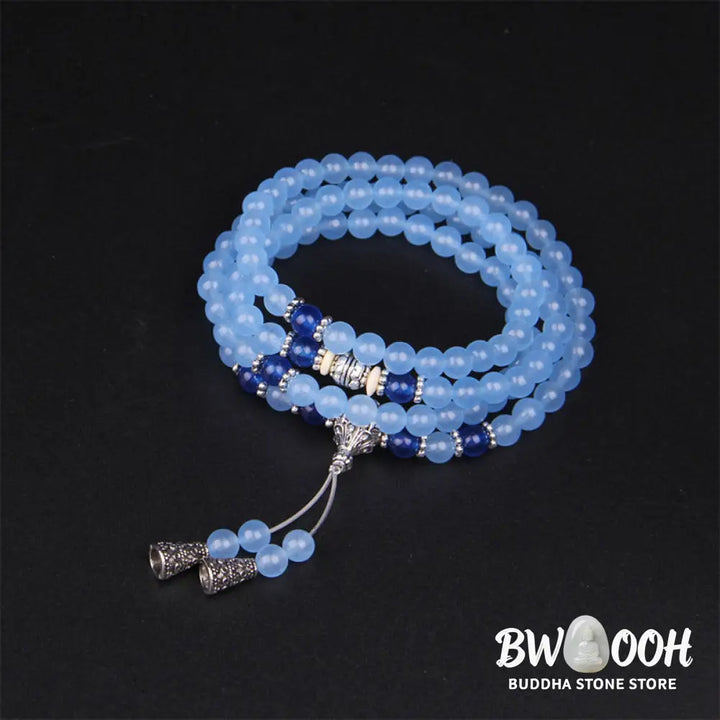 A BWOOOH 108-bead Blue Crystal Healing Mala Bracelet, featuring shimmering 6mm blue crystal beads, styled as a versatile bracelet and necklace. The natural variations in the blue crystals are visible, emphasizing its serene and handcrafted quality, perfect for meditation and spiritual balance. - View 6