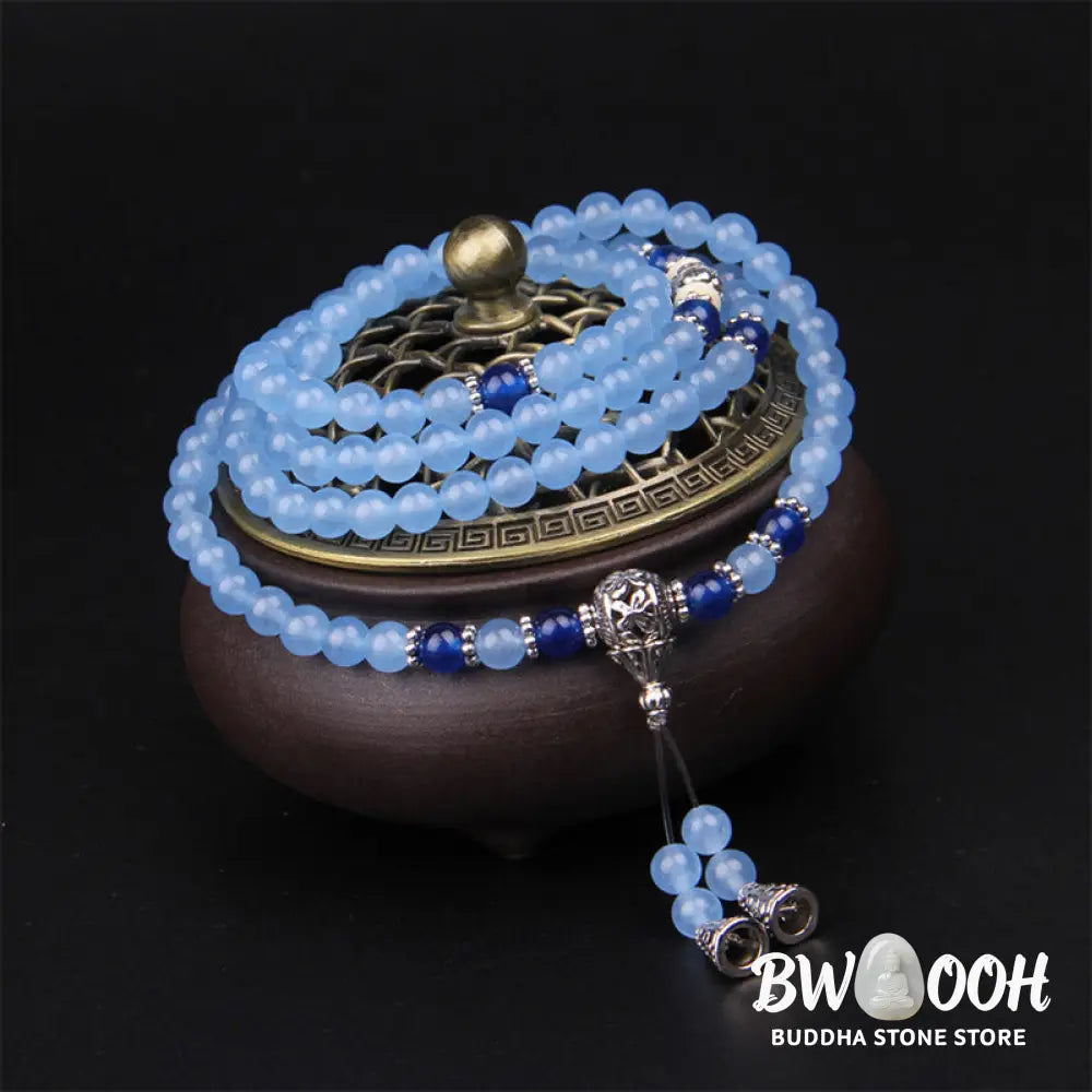 A BWOOOH 108-bead Blue Crystal Healing Mala Bracelet, featuring shimmering 6mm blue crystal beads, styled as a versatile bracelet and necklace. The natural variations in the blue crystals are visible, emphasizing its serene and handcrafted quality, perfect for meditation and spiritual balance. - View 5