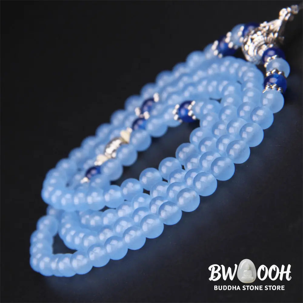 A BWOOOH 108-bead Blue Crystal Healing Mala Bracelet, featuring shimmering 6mm blue crystal beads, styled as a versatile bracelet and necklace. The natural variations in the blue crystals are visible, emphasizing its serene and handcrafted quality, perfect for meditation and spiritual balance. - View 8
