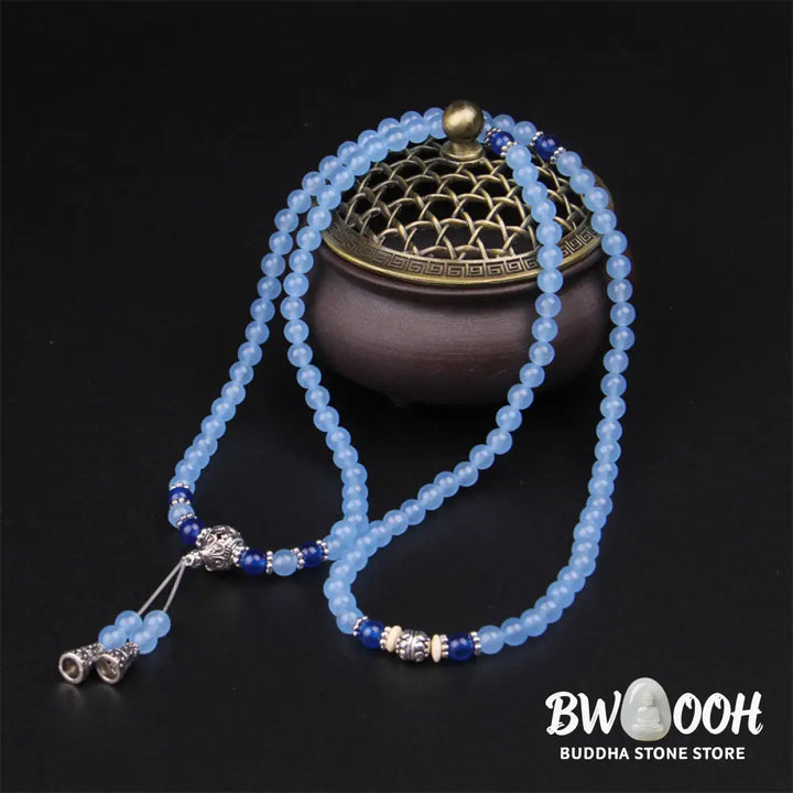 A BWOOOH 108-bead Blue Crystal Healing Mala Bracelet, featuring shimmering 6mm blue crystal beads, styled as a versatile bracelet and necklace. The natural variations in the blue crystals are visible, emphasizing its serene and handcrafted quality, perfect for meditation and spiritual balance. - View 3