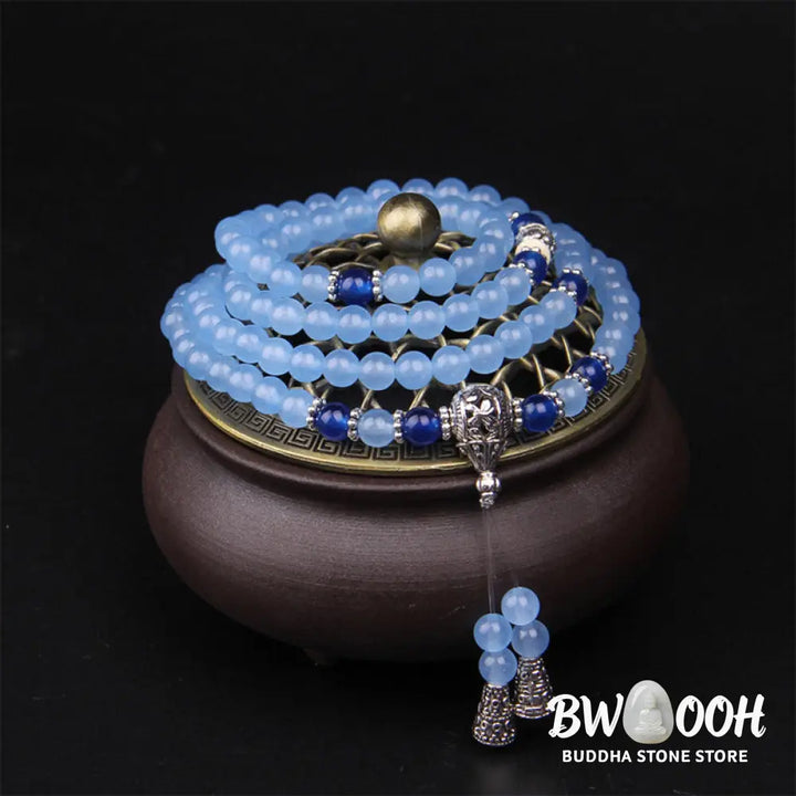 A BWOOOH 108-bead Blue Crystal Healing Mala Bracelet, featuring shimmering 6mm blue crystal beads, styled as a versatile bracelet and necklace. The natural variations in the blue crystals are visible, emphasizing its serene and handcrafted quality, perfect for meditation and spiritual balance. - View 2