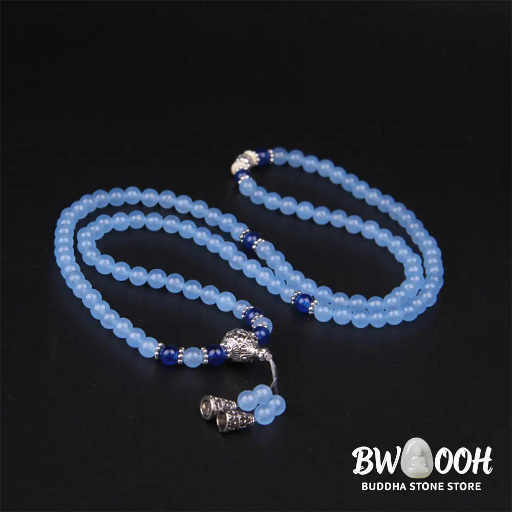 A BWOOOH 108-bead Blue Crystal Healing Mala Bracelet, featuring shimmering 6mm blue crystal beads, styled as a versatile bracelet and necklace. The natural variations in the blue crystals are visible, emphasizing its serene and handcrafted quality, perfect for meditation and spiritual balance. - View 7
