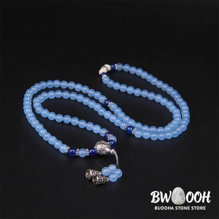 A BWOOOH 108-bead Blue Crystal Healing Mala Bracelet, featuring shimmering 6mm blue crystal beads, styled as a versatile bracelet and necklace. The natural variations in the blue crystals are visible, emphasizing its serene and handcrafted quality, perfect for meditation and spiritual balance. - View 7