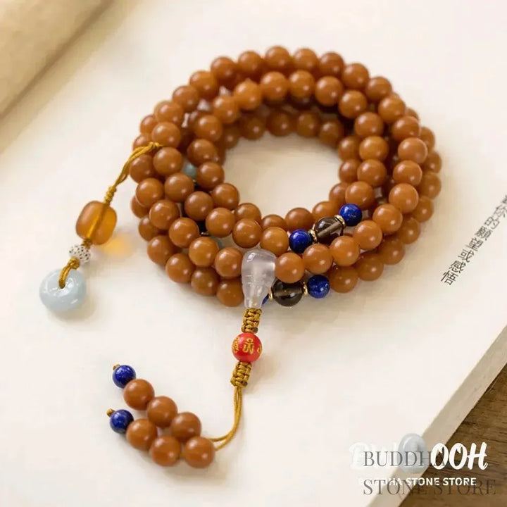 BWOOOH 108-bead Bodhi Seed meditation mala bracelet, featuring 8mm dark-speckled Bodhi seeds interspersed with vibrant red Cinnabar, rich green Jade, and golden Citrine accents. Designed for mindfulness, spiritual balance, and positive energy on a 90cm strand, worn five circles on a wrist. - View 7