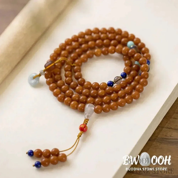 BWOOOH 108-bead Bodhi Seed meditation mala bracelet, featuring 8mm dark-speckled Bodhi seeds interspersed with vibrant red Cinnabar, rich green Jade, and golden Citrine accents. Designed for mindfulness, spiritual balance, and positive energy on a 90cm strand, worn five circles on a wrist. - View 9