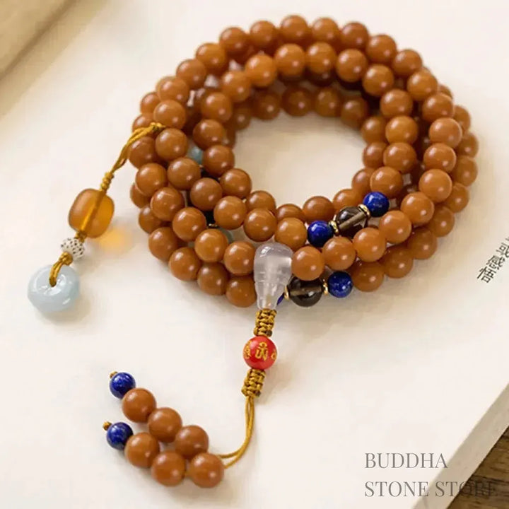 BWOOOH 108-bead Bodhi Seed meditation mala bracelet, featuring 8mm dark-speckled Bodhi seeds interspersed with vibrant red Cinnabar, rich green Jade, and golden Citrine accents. Designed for mindfulness, spiritual balance, and positive energy on a 90cm strand, worn five circles on a wrist. - View 10
