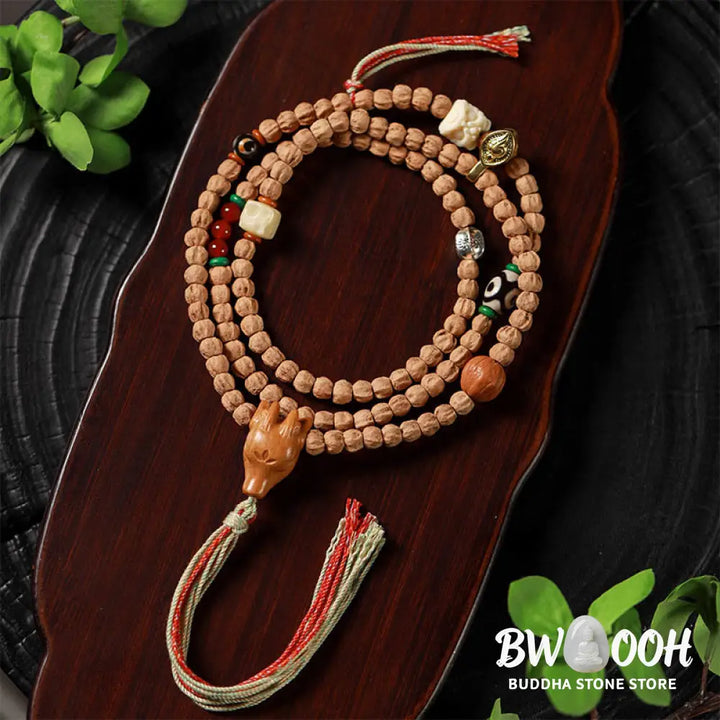 BWOOOH 108-bead Wisdom Mala bracelet featuring natural dark Bodhi Seeds, vibrant red agate beads, and a detailed deer head charm, displayed on a serene background, perfect for meditation and spiritual balance. - View 7