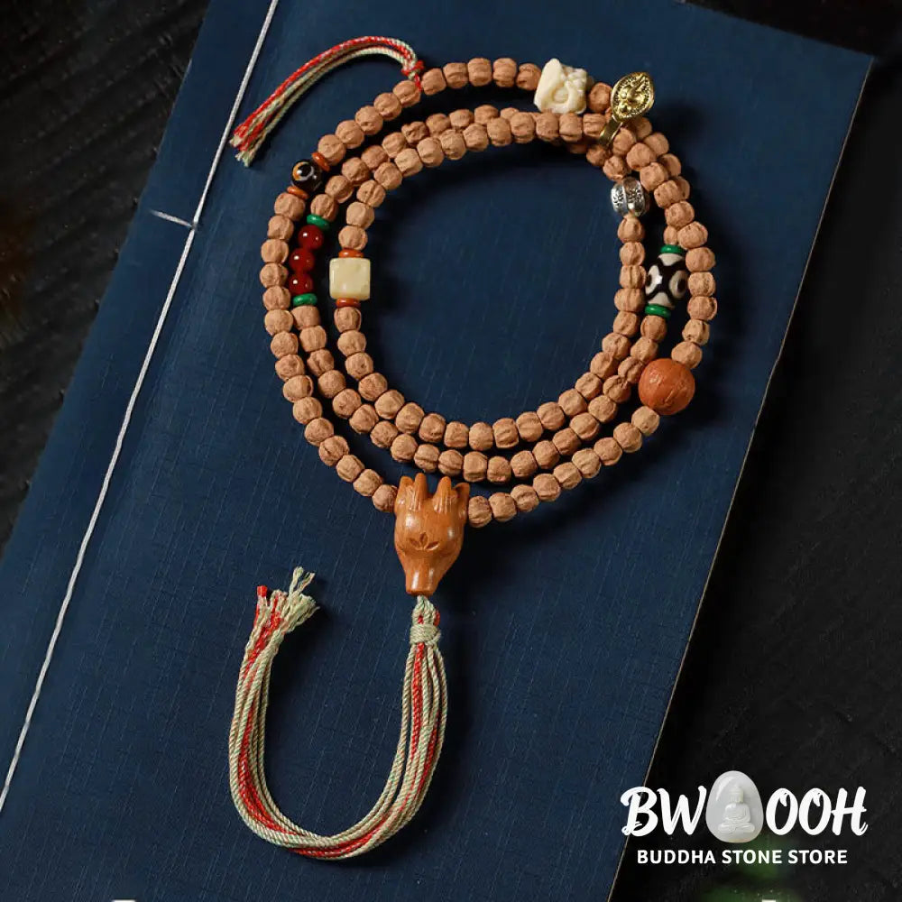 BWOOOH 108-bead Wisdom Mala bracelet featuring natural dark Bodhi Seeds, vibrant red agate beads, and a detailed deer head charm, displayed on a serene background, perfect for meditation and spiritual balance. - View 2