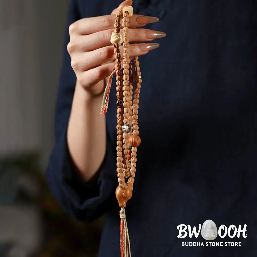 BWOOOH 108-bead Wisdom Mala bracelet featuring natural dark Bodhi Seeds, vibrant red agate beads, and a detailed deer head charm, displayed on a serene background, perfect for meditation and spiritual balance. - View 8