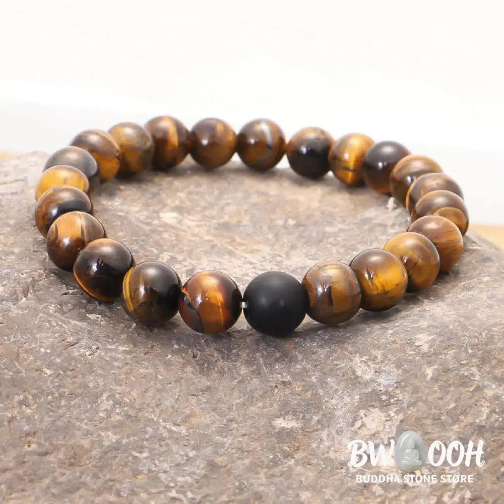 A BWOOOH 108-bead Tiger Eye protection mala bracelet with a matching tassel, showcased on a wrist for meditation and daily spiritual practice, emphasizing courage and positive energy. - View 6