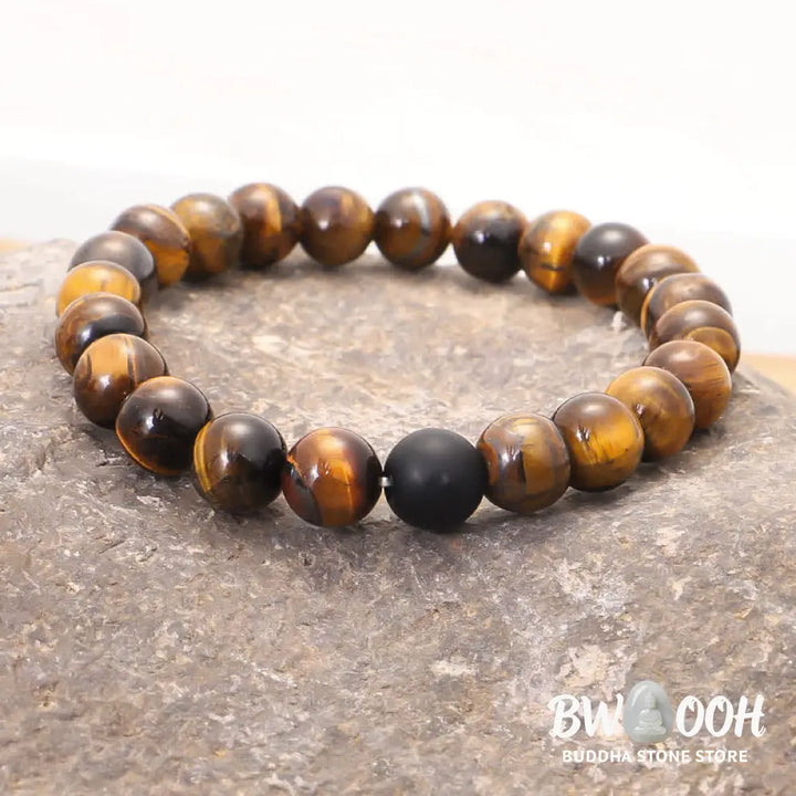 A BWOOOH 108-bead Tiger Eye protection mala bracelet with a matching tassel, showcased on a wrist for meditation and daily spiritual practice, emphasizing courage and positive energy. - View 6