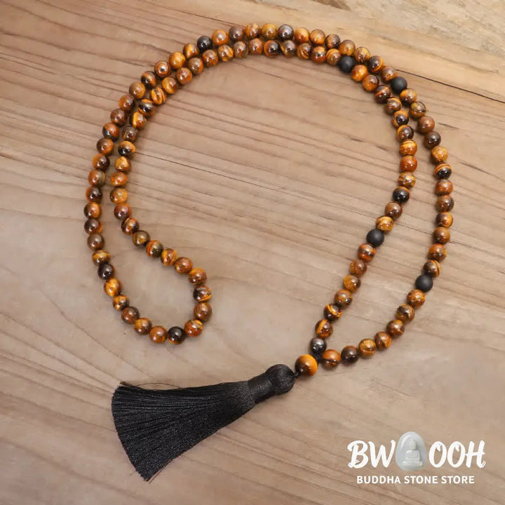 A BWOOOH 108-bead Tiger Eye protection mala bracelet with a matching tassel, showcased on a wrist for meditation and daily spiritual practice, emphasizing courage and positive energy. - View 10