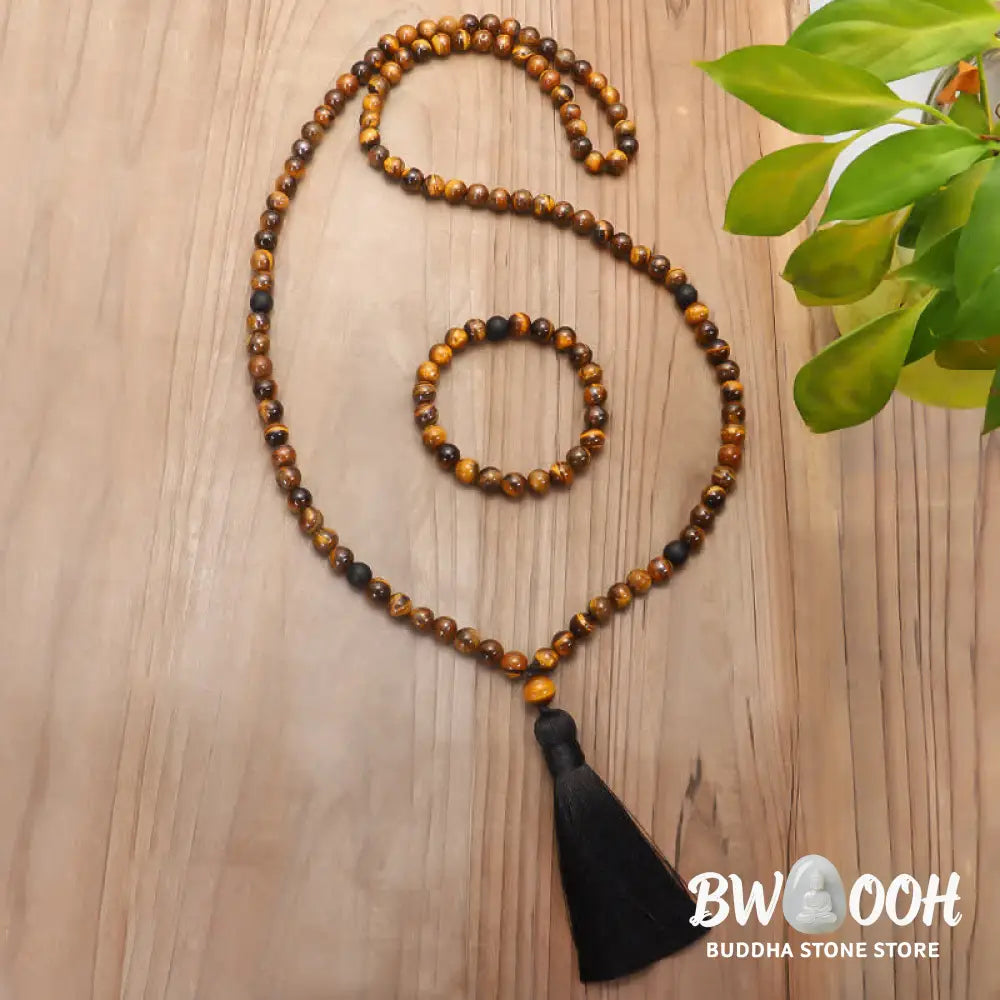 A BWOOOH 108-bead Tiger Eye protection mala bracelet with a matching tassel, showcased on a wrist for meditation and daily spiritual practice, emphasizing courage and positive energy. - View 3