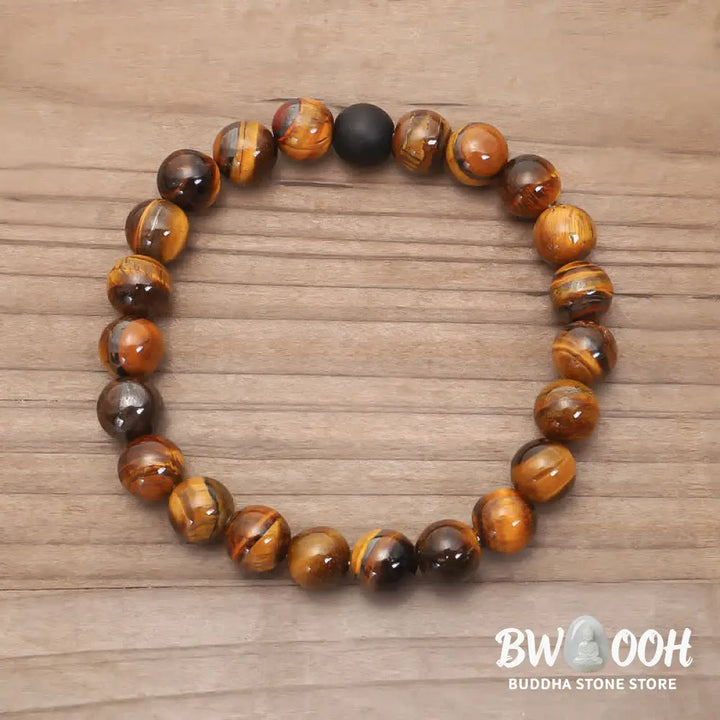 A BWOOOH 108-bead Tiger Eye protection mala bracelet with a matching tassel, showcased on a wrist for meditation and daily spiritual practice, emphasizing courage and positive energy. - View 5