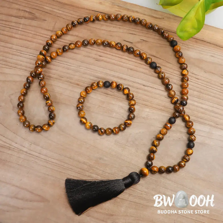 A BWOOOH 108-bead Tiger Eye protection mala bracelet with a matching tassel, showcased on a wrist for meditation and daily spiritual practice, emphasizing courage and positive energy. - View 2