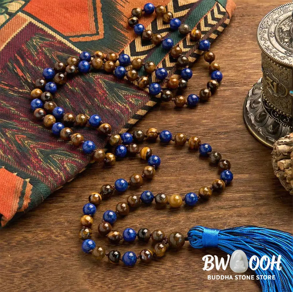 BWOOOH 108-bead mala bracelet featuring polished brown Tiger Eye and deep blue Lazurite Lapis Lazuli stones with a traditional tassel, symbolizing protection and wisdom for mindfulness. - View 2