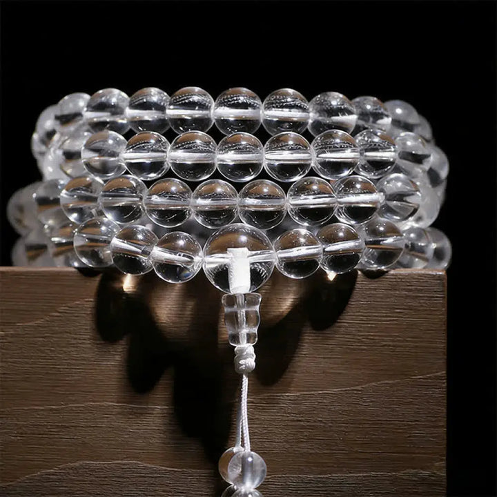 Close-up of BWOOOH 108 Clear Quartz Protection Mala, featuring polished 6mm or 8mm white crystal beads on elastic string, suitable for meditation and wrist wear.