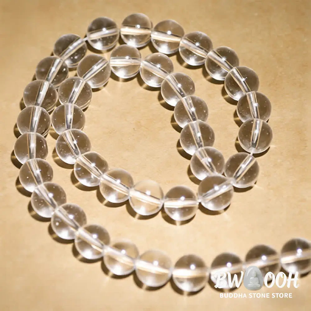 Close-up of BWOOOH 108 Clear Quartz Protection Mala, featuring polished 6mm or 8mm white crystal beads on elastic string, suitable for meditation and wrist wear. - View 11