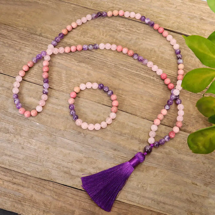 BWOOOH 108 Amethyst Rose Quartz Mala beads bracelet with a delicate tassel, handcrafted for meditation, stress relief, and fostering self-love and inner peace. The smooth purple Amethyst and soft pink Rose Quartz gemstones are clearly visible on a premium elastic string, ready to be worn as a bracelet or necklace.