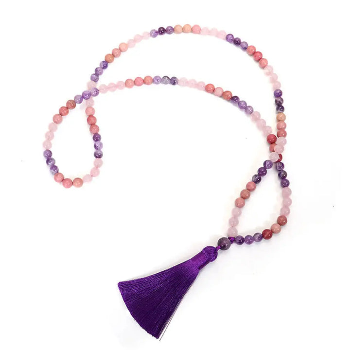 BWOOOH 108 Amethyst Rose Quartz Mala beads bracelet with a delicate tassel, handcrafted for meditation, stress relief, and fostering self-love and inner peace. The smooth purple Amethyst and soft pink Rose Quartz gemstones are clearly visible on a premium elastic string, ready to be worn as a bracelet or necklace. - View 7