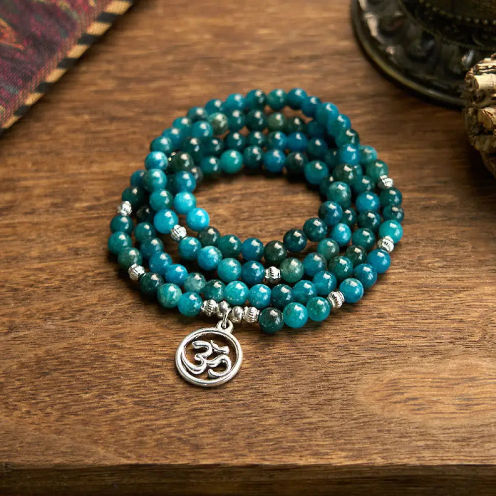 BWOOOH Apatite 108 Mala Beads bracelet with an intricate Om, Tree of Life, or Lotus pendant. This 6mm natural apatite bead mala is designed for meditation, spiritual clarity, and balancing inner energy.