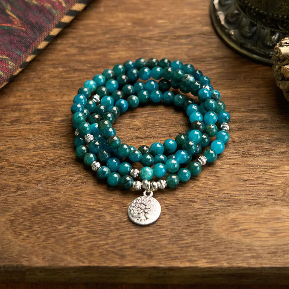 BWOOOH Apatite 108 Mala Beads bracelet with an intricate Om, Tree of Life, or Lotus pendant. This 6mm natural apatite bead mala is designed for meditation, spiritual clarity, and balancing inner energy. - View 7