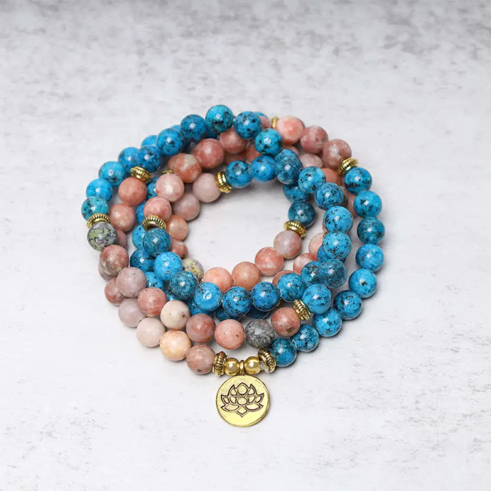A close-up of the BWOOOH 108 Mala Beads Apatite Red Stone Lotus Meditation Prayer Bead Bracelet, showcasing the vibrant 8mm Apatite and Red Stone beads, intricate Lotus symbol, and premium elastic string, ready for mindfulness practice.