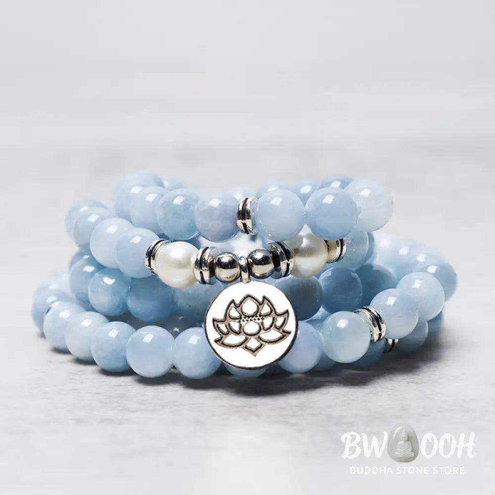 A close-up of the BWOOOH 108-bead Aquamarine Mala healing bracelet, featuring hand-grinded 8mm blue aquamarine crystals, aesthetic circle spacers, and a central aluminum lotus engraving, designed for meditation and spiritual balance. - View 3