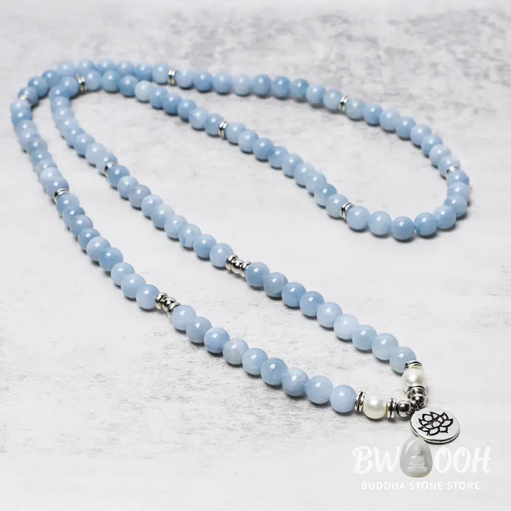 A close-up of the BWOOOH 108-bead Aquamarine Mala healing bracelet, featuring hand-grinded 8mm blue aquamarine crystals, aesthetic circle spacers, and a central aluminum lotus engraving, designed for meditation and spiritual balance. - View 2