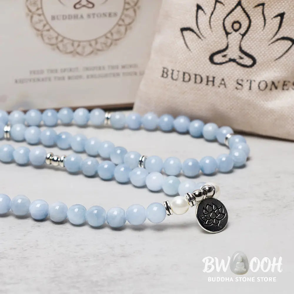 A close-up of the BWOOOH 108-bead Aquamarine Mala healing bracelet, featuring hand-grinded 8mm blue aquamarine crystals, aesthetic circle spacers, and a central aluminum lotus engraving, designed for meditation and spiritual balance. - View 5